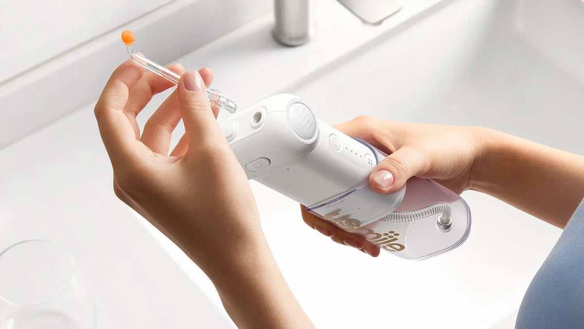 Attaching a jet tip to a portable water flosser over a bathroom sink